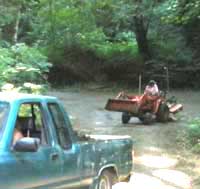 Owner of Persephone Farm taking some pickup truck-loads of dirt